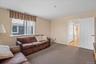 Living room featuring light carpet and baseboards
