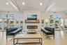 Living room featuring beamed ceiling, wood finished floors, french doors, a fireplace, and high vaulted ceiling
