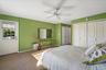 Carpeted bedroom featuring baseboards and ceiling fan