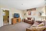 Carpeted living room featuring baseboards
