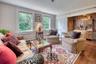 Living room featuring wood finished floors and a bar