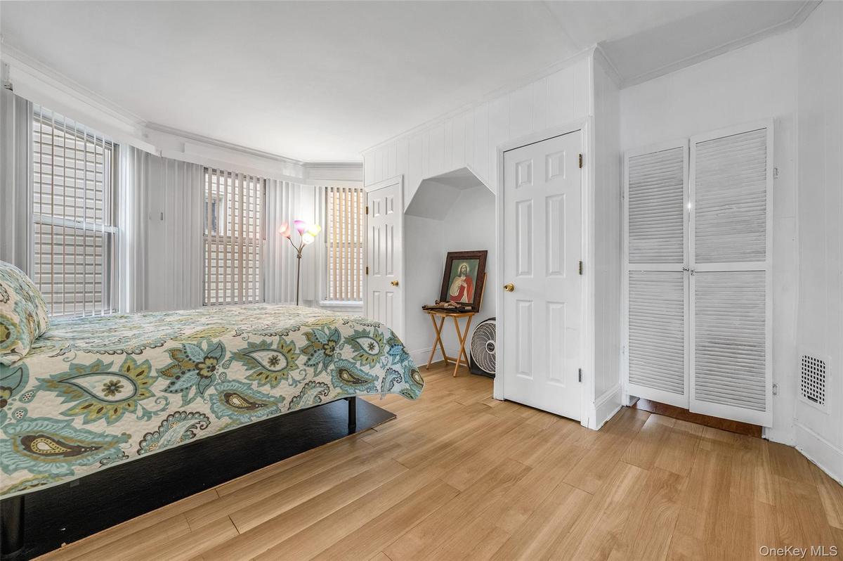 Bedroom featuring crown molding and light wood finished floors