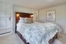 Bedroom featuring carpet floors and baseboards