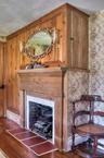 Detailed view of wood finished floors and a premium fireplace