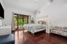 Bedroom with access to outside, a wall mounted air conditioner, wood finished floors, and high vaulted ceiling