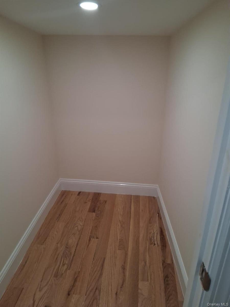 Empty room with wood finished floors and recessed lighting