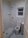 Full bath with vanity, a marble finish shower, and marble finish flooring