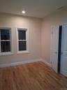 Empty room with light wood-type flooring and recessed lighting