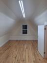 Bonus room featuring light wood-style floors and vaulted ceiling