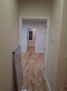 Hall with light wood-style floors and baseboards