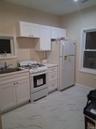 Kitchen with white cabinets and white appliances