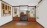 Unfurnished living room featuring a glass covered fireplace, wood finished floors, crown molding, and recessed lighting