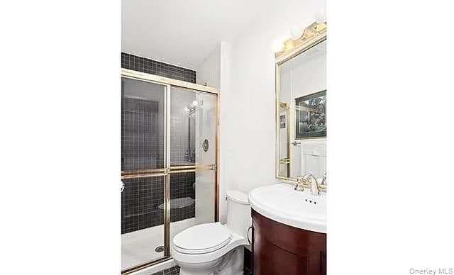 Full bath featuring vanity and a stall shower