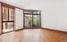 Empty room featuring wood finished floors and a wall of windows