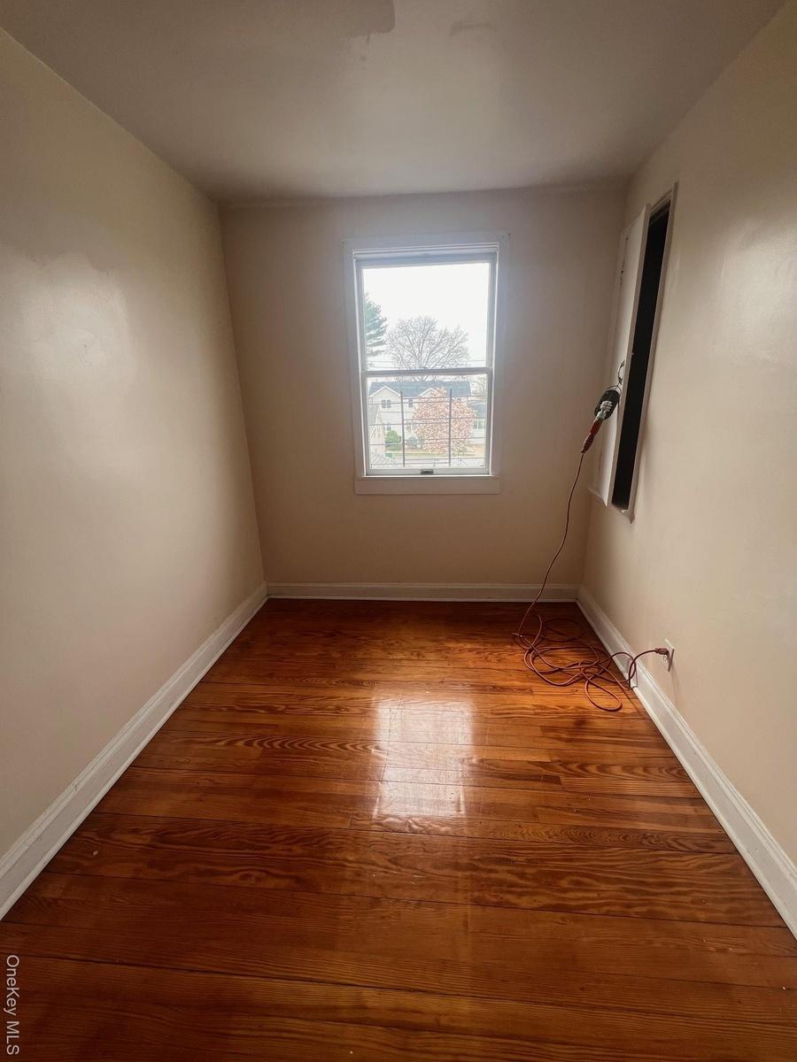 Unfurnished room with baseboards and light wood-style floors