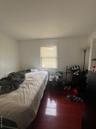 Bedroom with dark wood-type flooring