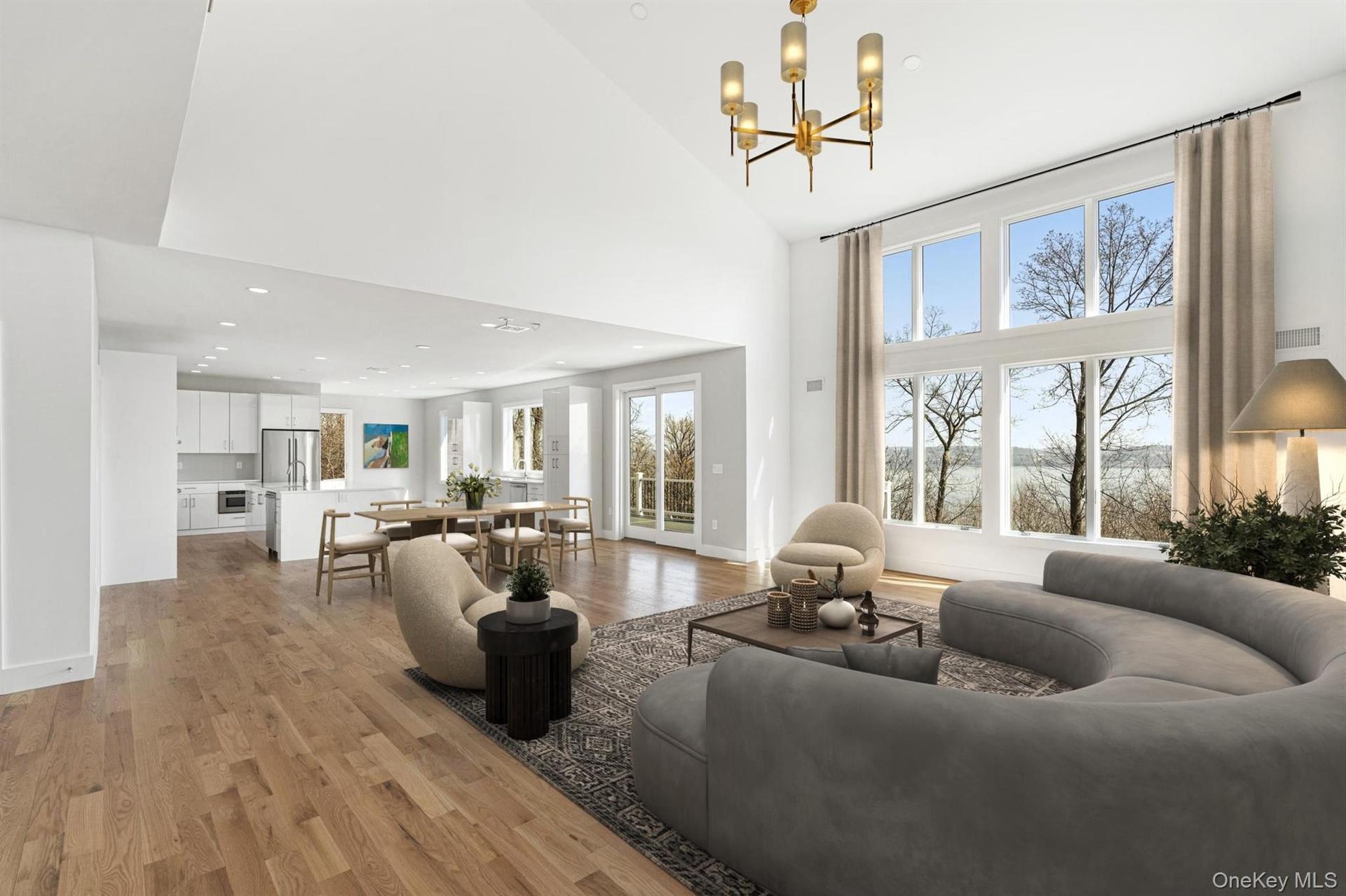 Impressive Great Room open to the Chef's kitchen with deck access virtually staged