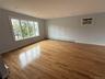 Empty room with light wood-style flooring, recessed lighting, a baseboard radiator, and a wall unit AC