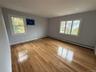 Unfurnished room featuring healthy amount of natural light, light wood-style floors, a baseboard heating unit, and recessed lighting