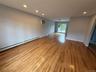 Empty room with baseboard heating, recessed lighting, light wood-style flooring, and a wall mounted AC