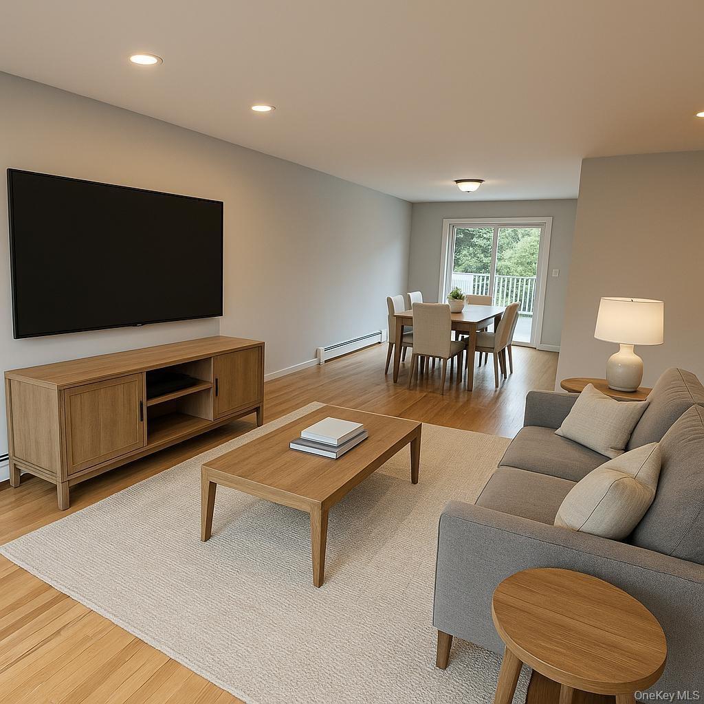 Living room featuring recessed lighting, light wood-style flooring, and a baseboard radiator