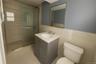 Full bath with a stall shower, vanity, light tile patterned floors, and tile walls