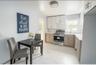 Kitchen featuring light marble finish flooring, electric stove, backsplash, a baseboard radiator, and white cabinetry