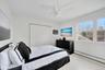 Bedroom featuring baseboard heating, wood finished floors, a closet, and ceiling fan