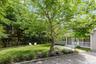 View of grassy yard featuring a porch