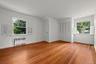 Bonus room featuring radiator heating unit and light wood-style flooring