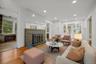 Living area featuring wood finished floors, a fireplace, and recessed lighting