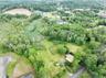 View of property location featuring a forest
