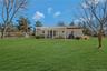 Back of house and yard featuring pergola and patio,