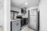 Kitchen with open shelves, gray cabinetry, stainless steel appliances, light countertops, and recessed lighting