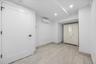 Below grade area with recessed lighting and a wall mounted AC