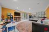 Living room with crown molding, recessed lighting, and a wall unit AC