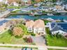 Aerial perspective of suburban area featuring a large body of water