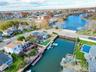 Aerial view of residential area featuring a nearby body of water