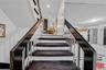 Staircase featuring a textured ceiling