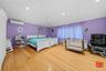 Bedroom featuring vaulted ceiling, light wood-style flooring, recessed lighting, and a wall mounted air conditioner