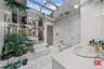 Bathroom with tile walls, a garden tub, vanity, and a skylight