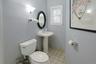 Half bathroom featuring light tile patterned floors and toilet