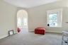 Living area featuring carpet flooring and arched walkways