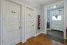 Foyer entrance featuring dark wood-style flooring and baseboards