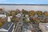 Aerial perspective of suburban area featuring a nearby body of water