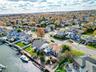 Aerial perspective of suburban area featuring a large body of water