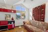 Living area featuring vaulted ceiling, wood finished floors, and a ceiling fan