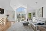 Living room featuring light wood finished floors, recessed lighting, and high vaulted ceiling