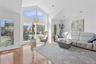 Living room featuring wood finished floors, high vaulted ceiling, and recessed lighting