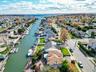 Aerial perspective of suburban area featuring a large body of water